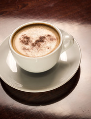 Cup of coffee on a wooden table in restaurant