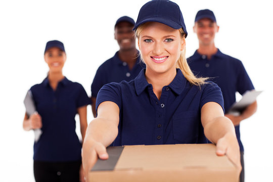 friendly young delivery woman presenting parcel with colleagues