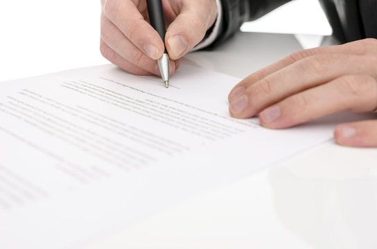 Closeup of a man signing a contract