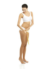 Female buttocks with a measurement tape.