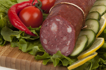 Sausage with vegetables on board