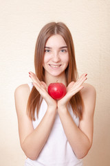 Beautiful blonde woman holding a red apple