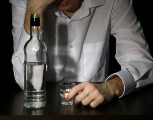 Man with bottle of alcohol,  on black background