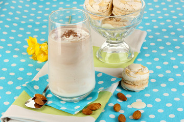 Glass of chocolate-cream cocktail on blue tablecloth close-up