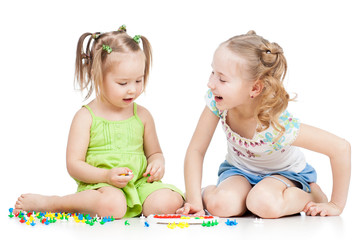 children sisters paly together, isolated on white background © Oksana Kuzmina