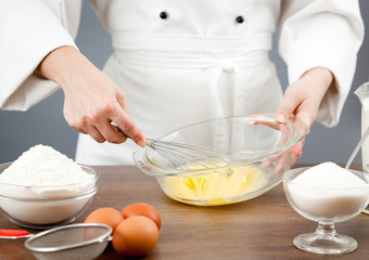 The woman the cook is occupied with dough preparation
