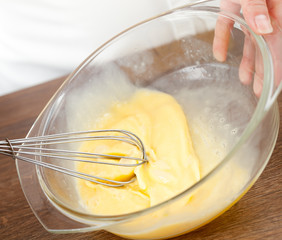 The woman the cook is occupied with dough preparation