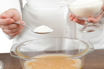 The woman the cook is occupied with dough preparation