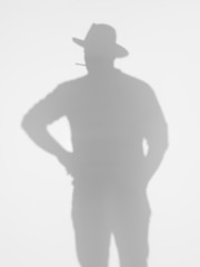 man silhouette smoking a cigarette