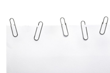 Paper clips on white piece of paper