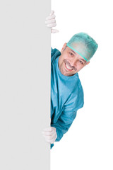 Doctor In Operation Gown Holding Blank Placard