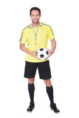 Soccer judge standing with ball