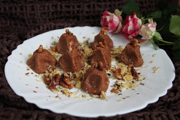 Homemade truffles with walnut in white plate