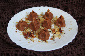 Homemade truffles with walnut in white plate