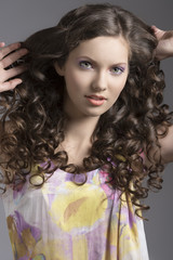 Fototapeta premium pretty brunette with curly hair smiles
