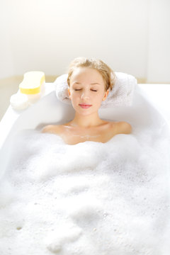 Attractive girl relaxing in bath