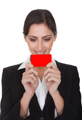 Smiling Businesswoman Holding Red Card