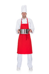 Portrait of cheerful chef holding pot