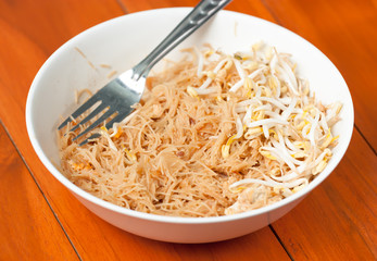 Stir fried mung bean noodle in bowl on the wooden table
