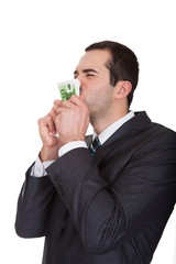 Excited businessman kissing euro notes