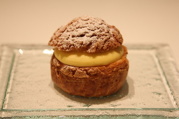 Choux pastry buns, filled with cream, on a plate
