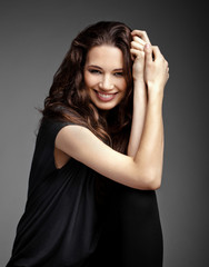 Naklejka premium Beautiful portrait of young brunette with hand close to face