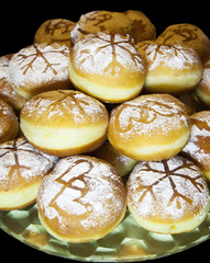 Sweet fresh baked donuts – isolated against black