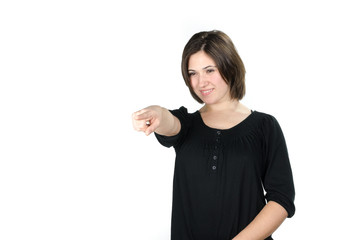 Portrait of young woman pointing in front of her