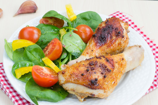 Healthy dinner: grilled chicken legs and salad