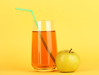 Useful apple juice with apples around on yellow background
