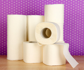 Rolls of toilet paper on purple with dots background