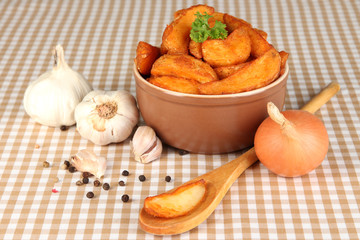 Appetizing village potatoes in bowl on beige tablecloth