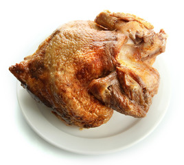 Tasty whole roasted chicken on plate, isolated on white