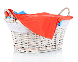 Clothes in wooden basket isolated on white