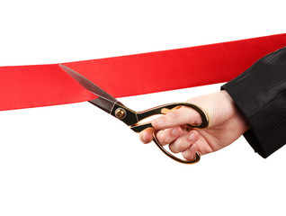 Cutting red ribbon, isolated on white
