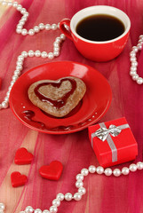 Chocolate cookie in form of heart with cup of coffee