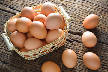 Eggs in basket on wooden table