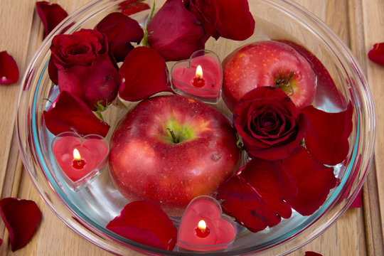 Apple with rose petals in glass bowl