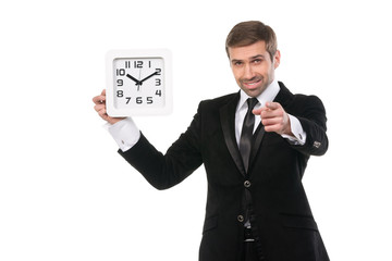 Handsome smiling businessman with a clock. Isolated over white