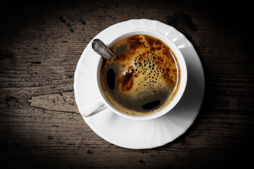 a cup of coffee on old wooden table - breakfast