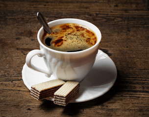 a cup of coffee and biscuits