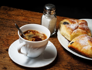a cup of coffee and cakes on old wooden table - breakfast