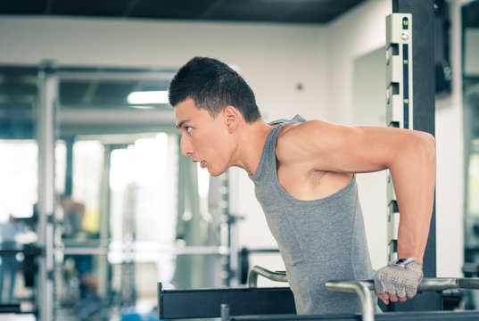 Young Asian Man Training In The Gym.