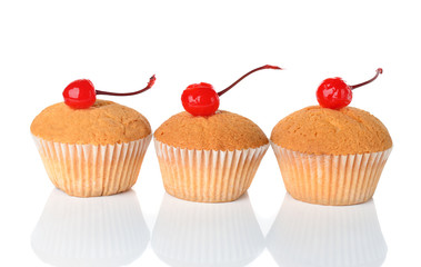Muffins decorated with cherry on white background