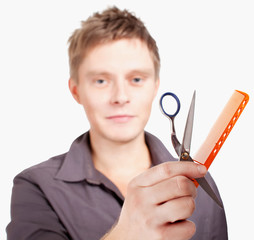 Young  stylich haircutter holding scissors and brush.Isolated ov
