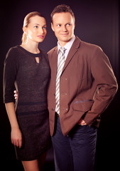 Man and Woman posing over dark background