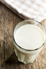 glass of milk on old wooden table