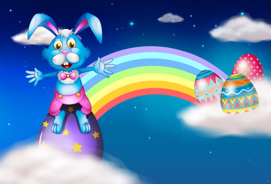 An easter bunny and eggs near the rainbow