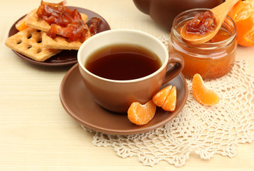 light breakfast with tea and homemade jam, on wooden table
