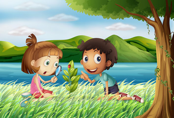 Obraz na płótnie Canvas Kids near the river with a magnifying glass